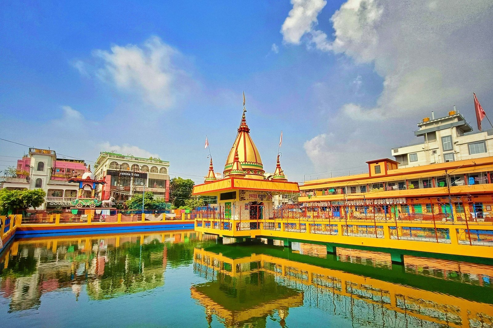 a bridge over a body of water with buildings in the background